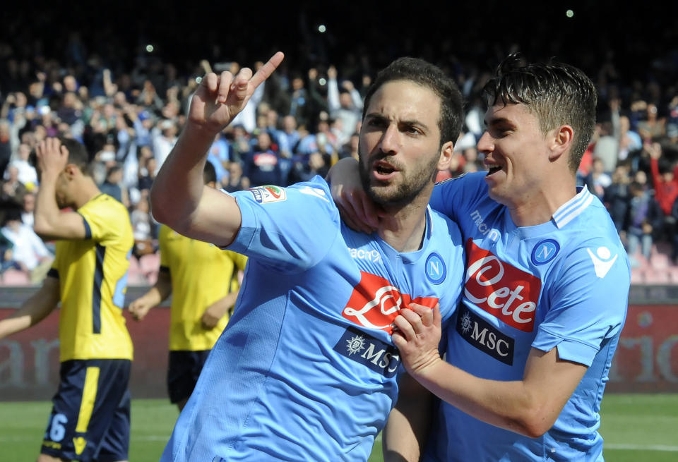 Napoli's Gonzalo Higuain, left, celebrates with teammate Jorginho after scoring during a Serie A soccer match between Napoli and Lazio, at the San Paolo stadium in Naples, Italy, Sunday, April, 13, 2014. (AP Photo/Salvatore Laporta)