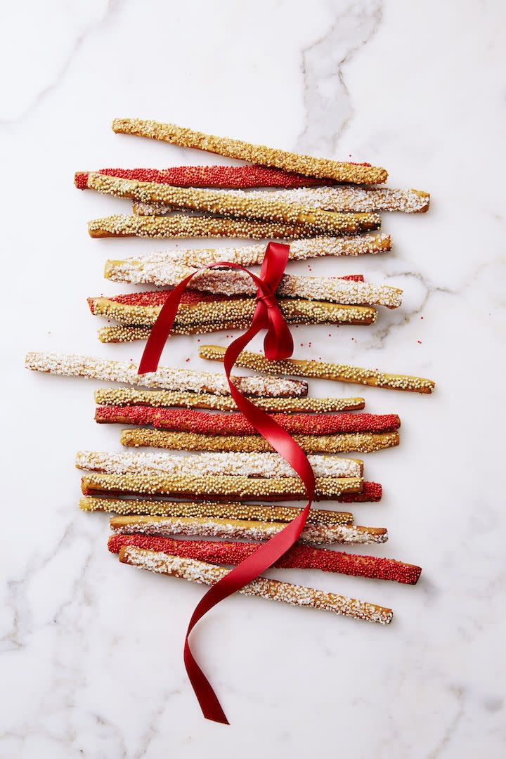 gingerbread wands with a red ribbon tied around them
