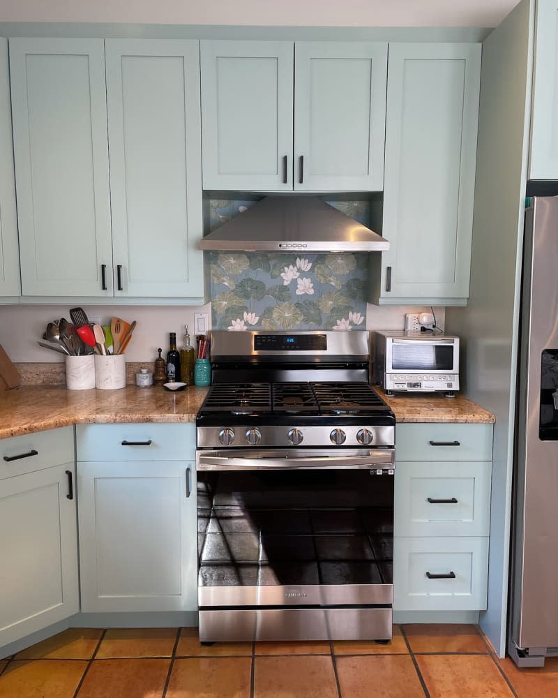 Green cabinets in kitchen after renovation.