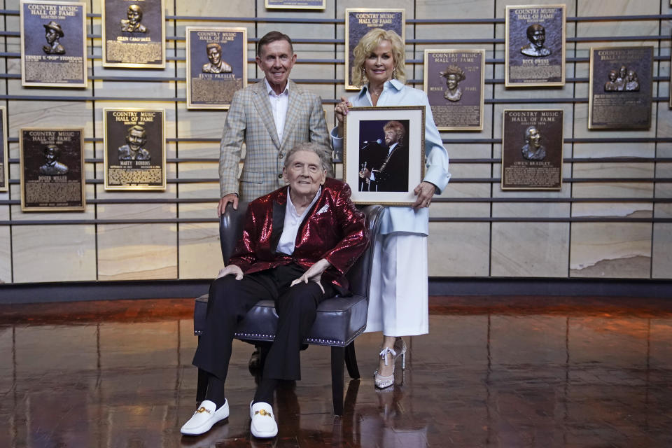 Music executive Joe Galante, left; singer Jerry Lee Lewis, center; and Lorrie Morgan, right, widow of country singer Keith Whitley; pose in the Country Music Hall of Fame Tuesday, May 17, 2022, in Nashville, Tenn. Galante, Lewis, and Whitley were announced Tuesday as the newest inductees. (AP Photo/Mark Humphrey)