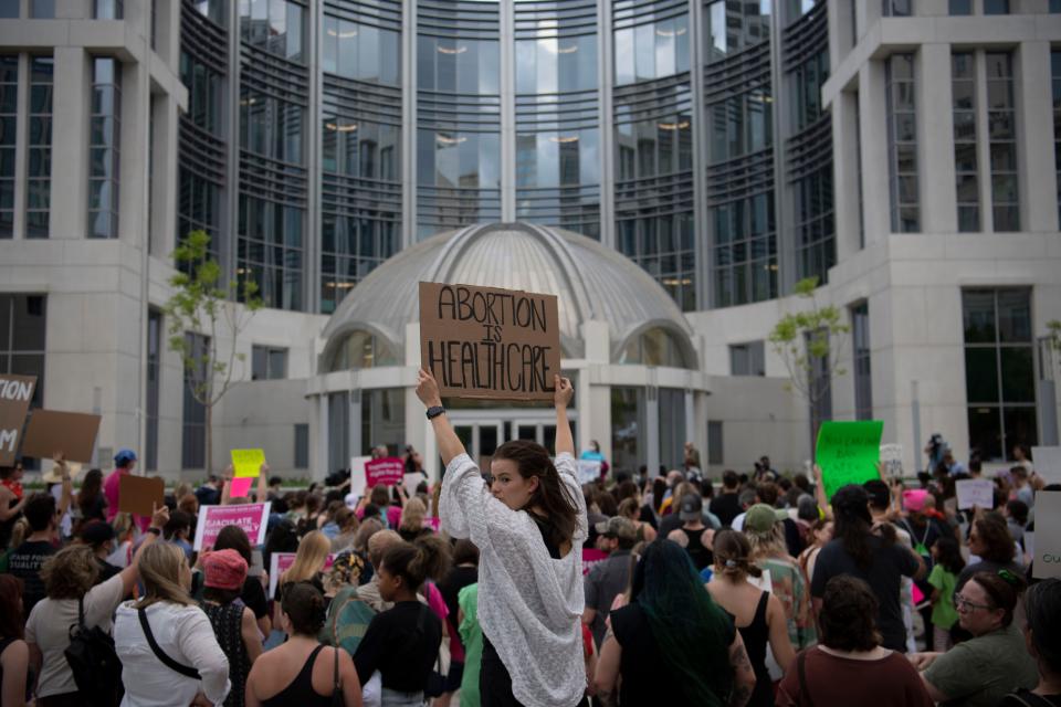 Laura Huff stands with other demonstrators to protest in response to the potential overturning of Roe V. Wade after a leaked document revealed the Supreme Court privately voted to strike down the case that guarantees the right to abortion at Federal Courthouse in Nashville, Tenn., Tuesday, May 3, 2022. The protest was part of a nation wide protest. 