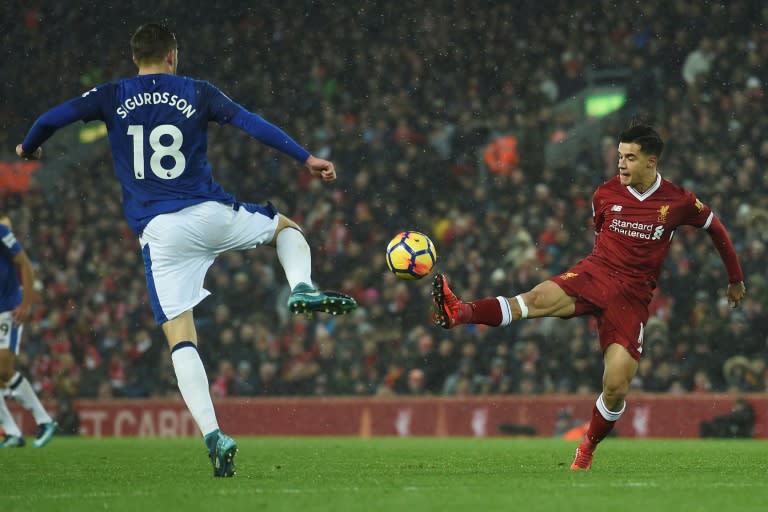 Liverpool's Philippe Coutinho (R) was left on the bench until the secodn half against Everton