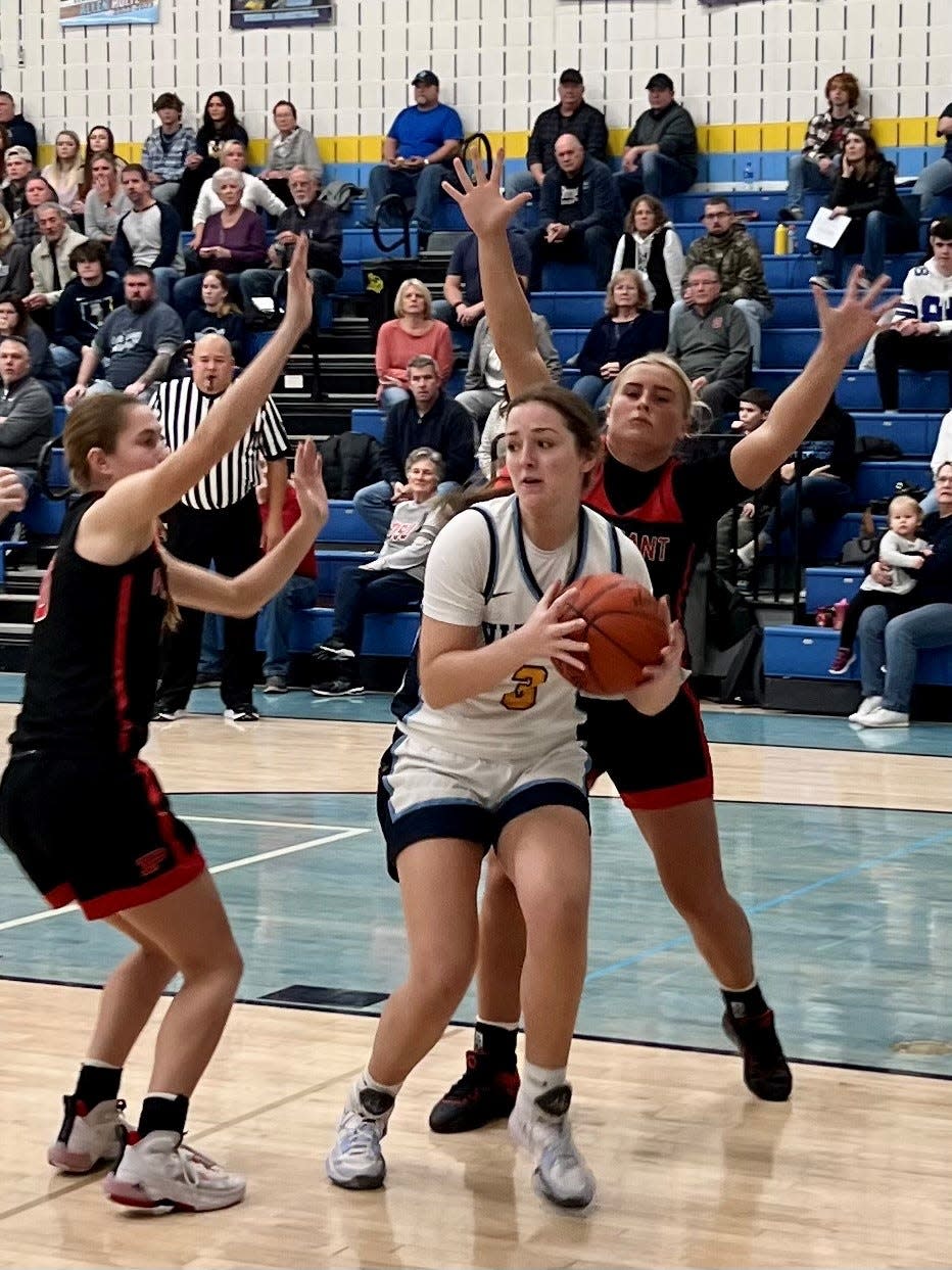 River Valley's Brooklyn Mosher drives the baseline while being defended by Pleasant's Whitney Waddell, left, and Lexi Olt during Friday night's Mid Ohio Athletic Conference girls basketball game at River Valley.