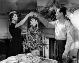 <p>While filming in London, Sophia Loren toasts William Holden during a scene in <em>The Key.</em> </p>