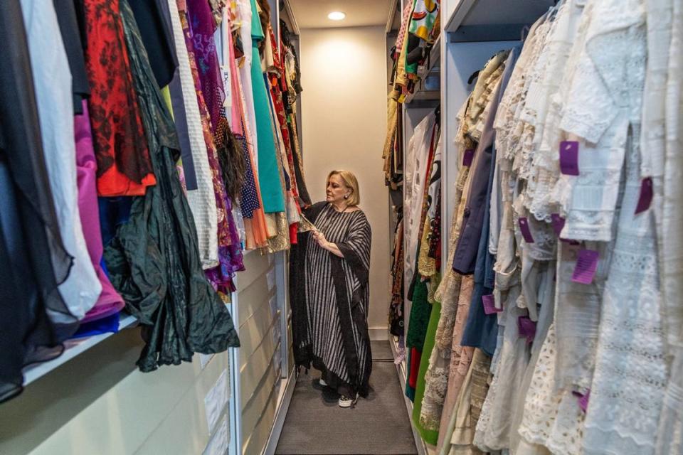 Paquita Parodi, founder of the Paquita Parodi Costume Collection, checks on some dresses in the vault of her collection in Miami. Paquita is a collector, restorer and fashion historian who worked on her first garment at the age of twelve when her grandmother challenged her to repair a chemise to its original state.n Tuesday May 23, 2023.