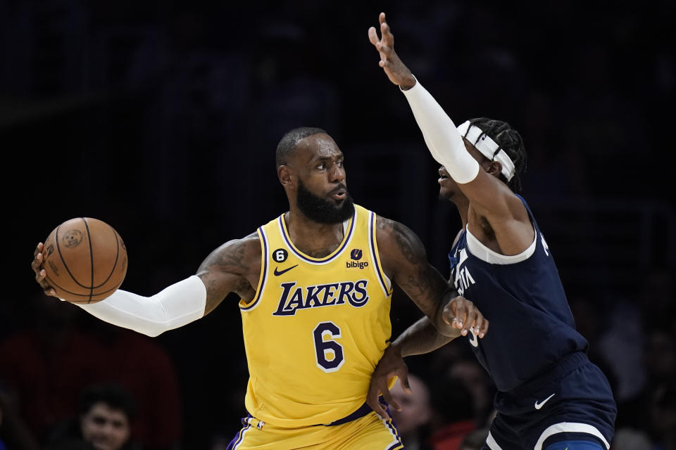 Minnesota Timberwolves' Jaden McDaniels, right, pressures Los Angeles Lakers' LeBron James during second half of an NBA preseason basketball game Wednesday, Oct. 12, 2022, in Los Angeles. (AP Photo/Jae C. Hong)