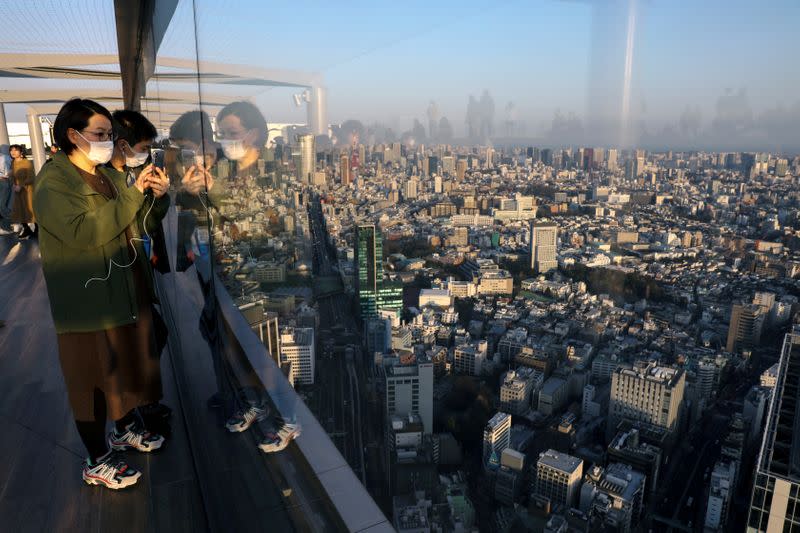 People wearing protective masks are seen at the Shibuya sky observation deck, following an outbreak of the coronavirus in Tokyo