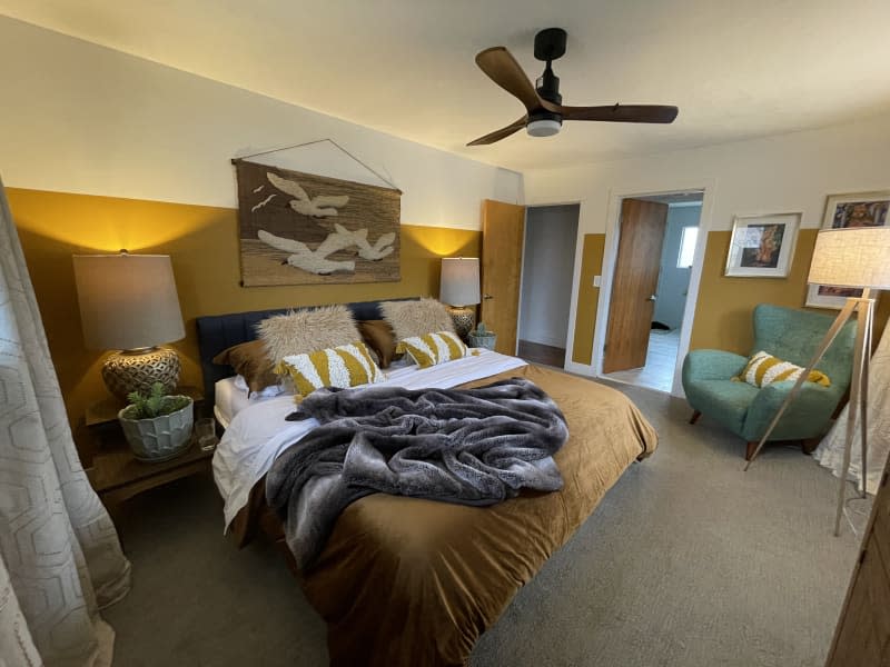 Master bedroom with yellow and white walls