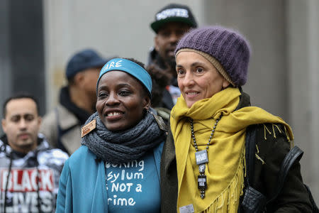 Therese Okoumou, Statue of Liberty climber, walks with an activist at the United States Courthouse in the Manhattan borough of New York City, New York, U.S., December 17, 2018. REUTERS/Jeenah Moon