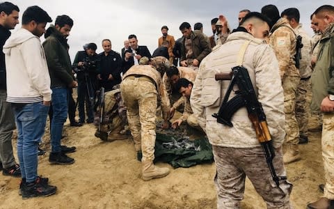  Iraqi security forces find and collect the pieces of missiles as they gather to inspect the site after Iran's Islamic Revolutionary Guard Corps (IRGC) targeted Ain al-Asad airbase in Iraq, a facility jointly operated by U.S. and Iraqi forces, at Bardarash district of Erbil in Iraq - Credit: Andalou