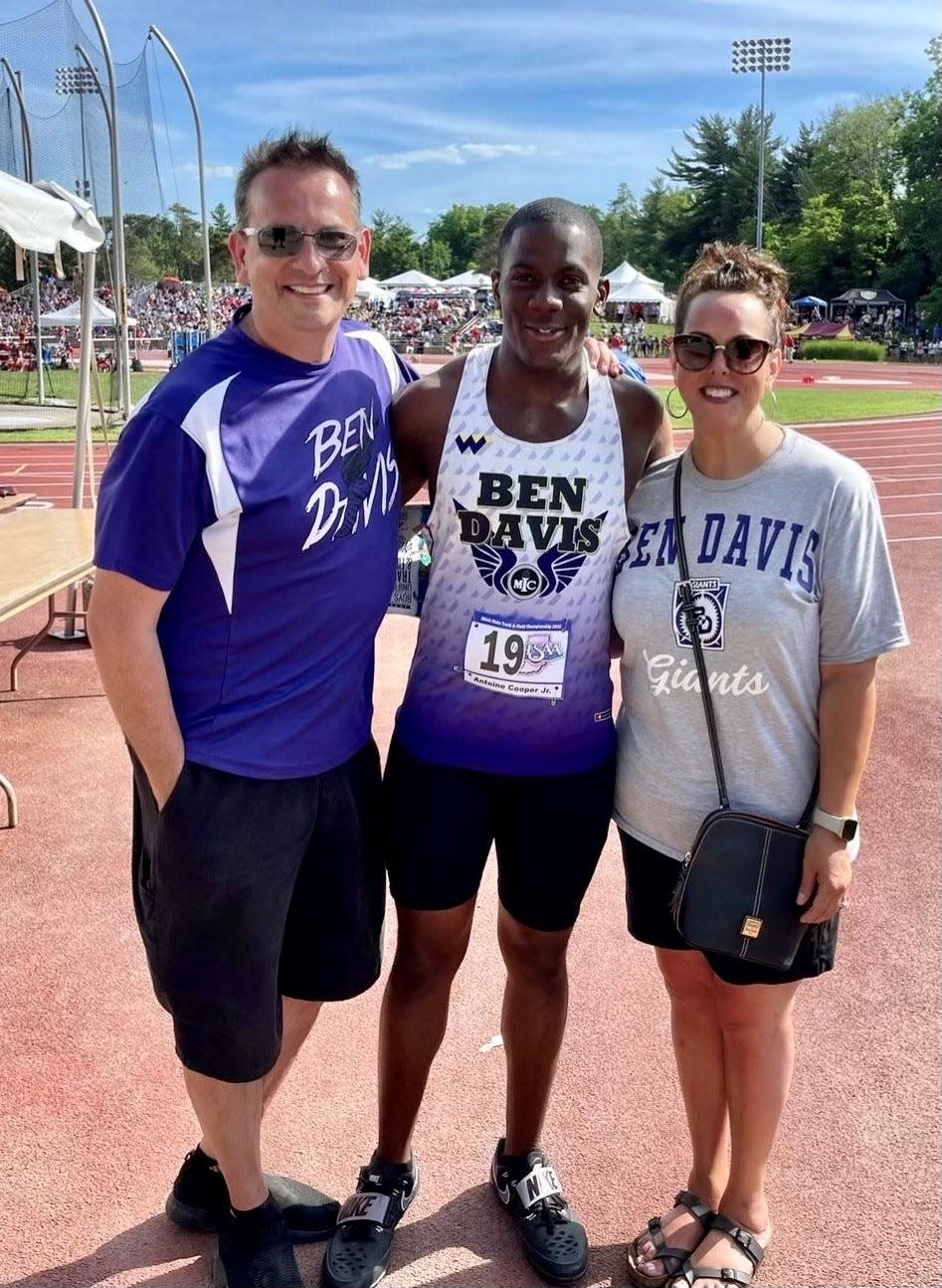 Discus state champion Antoine Cooper Jr. with guardians Russell Hylton, left, and Beverly Hylton.