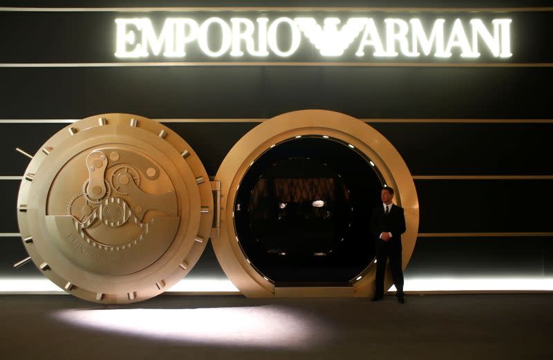 FILE PHOTO: A model stands in front of the exhibition stands of Emporio Armani at Baselworld fair in Basel