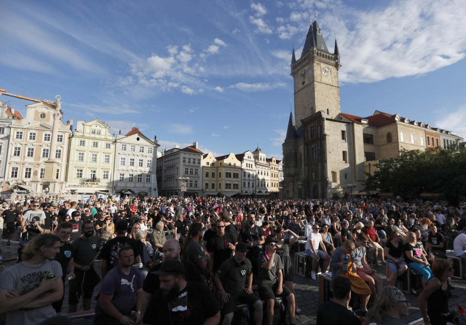 People gather for a demonstration in Prague, Czech Republic, Monday, July 27, 2020. Hundreds of musicians, concert promoters, club owners and other involved in the music industry rallied in Prague's Old Town Square to protest against government restrictions due to the coronavirus pandemic that they say ruin their business. (AP Photo/Petr David Josek)