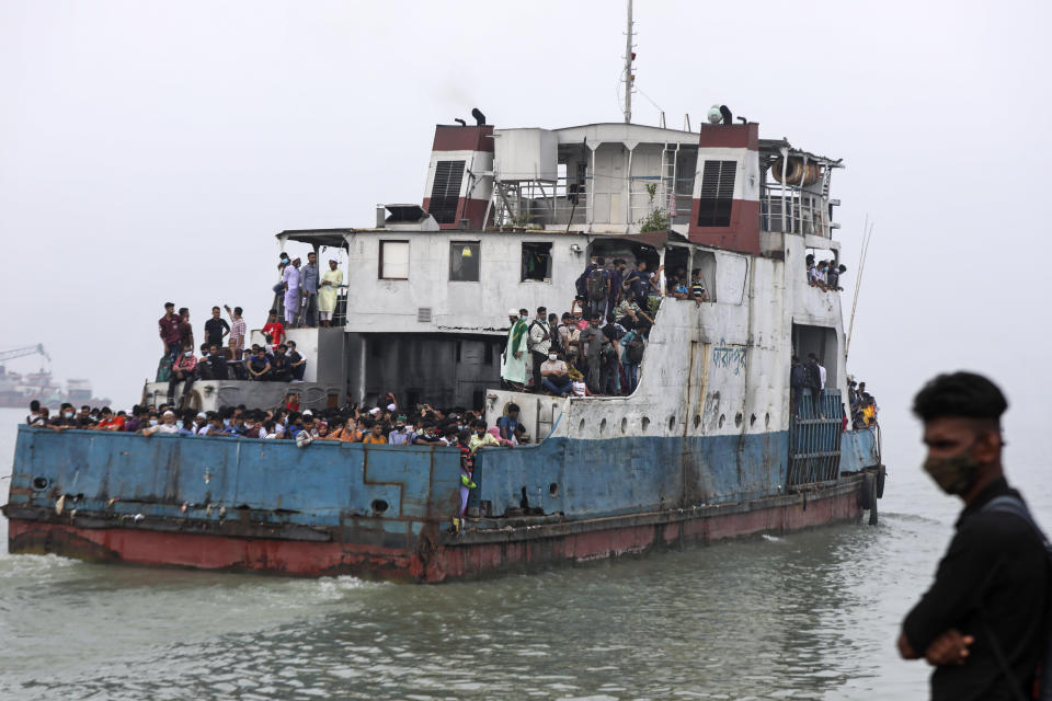 Thousands of people leaving for their native places to celebrate Eid-al-Fitr crowd a ferry at the Mawa terminal ignoring risks of coronavirus infection in Munshiganj, Bangladesh, Thursday, May 13, 2021. (AP Photo/Mahmud Hossain Opu)