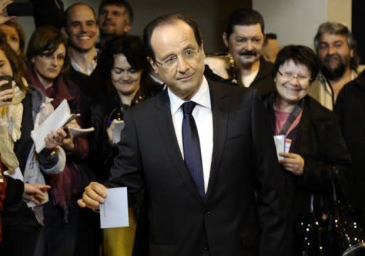 French Socialist Party (PS) candidate Francois Hollande (C) casts his ballot for the second round of the French presidential election, on May 6 in Tulle, southwest France