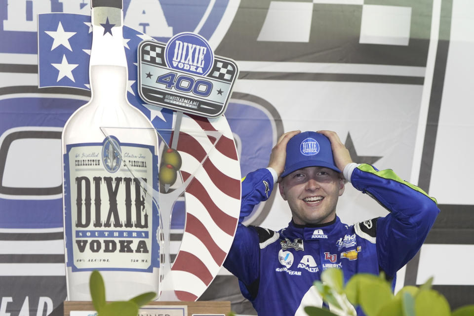 William Byron adjusts his cap as he celebrates after winning a NASCAR Cup Series auto race, Sunday, Feb. 28, 2021, in Homestead, Fla. (AP Photo/Wilfredo Lee)