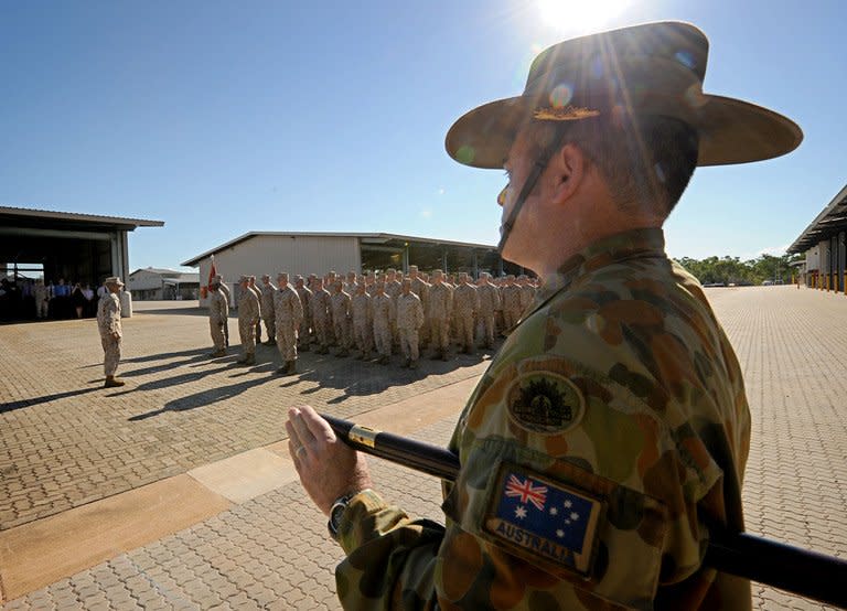 This file photo, released by the Australian Department of Defence on April 4, 2012, shows Australian Army Regimental Sergeant Major, Dale DeKock (R) parading the first contingent of 200 US Marines to be deployed in Australia near Darwin as Washington bolsters its military presence in the strategically vital region