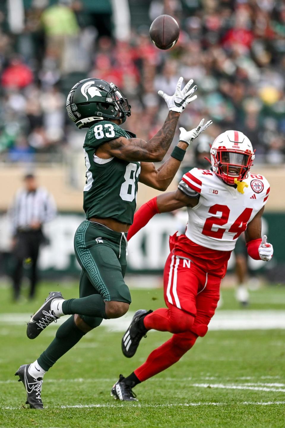 Michigan State's Montorie Foster Jr., left, catches a pass as Nebraska's Marques Buford Jr. defends during the second quarter on Saturday, Nov. 4, 2023, at Spartan Stadium in East Lansing.