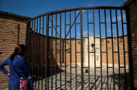 A visitor looks at a monument where Spanish Civil war victims are buried, in the old village of Belchite, in northern Spain, October 3, 2016. REUTERS/Andrea Comas