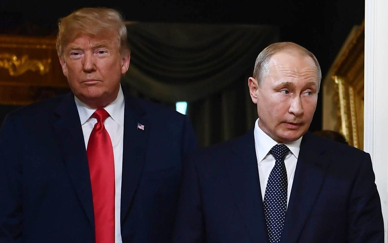 US President Donald Trump and Russian President Vladimir Putin arrive for a meeting in Helsinki - AFP