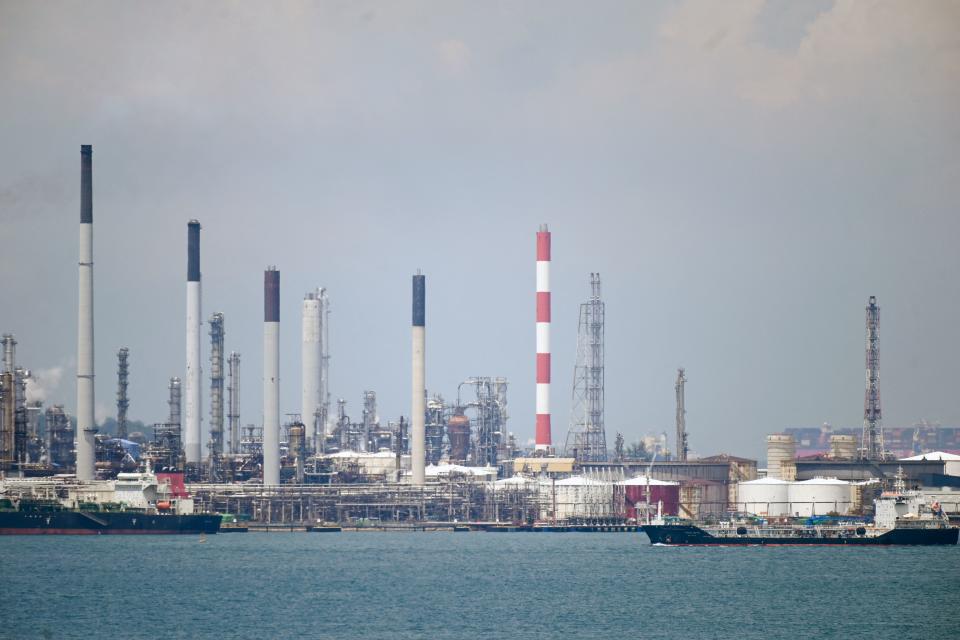 An oil tanker sails past Shell petroleum refineries on Bukom Island off Singapore on March 17, 2022. (Photo by ROSLAN RAHMAN/AFP via Getty Images)