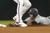 New York Yankees Oswald Peraza, bottom, slides in under Texas Rangers second baseman Marcus Semien (2) to steal second base during the fifth inning in the first baseball game of a doubleheader in Arlington, Texas, Tuesday, Oct. 4, 2022. (AP Photo/LM Otero)