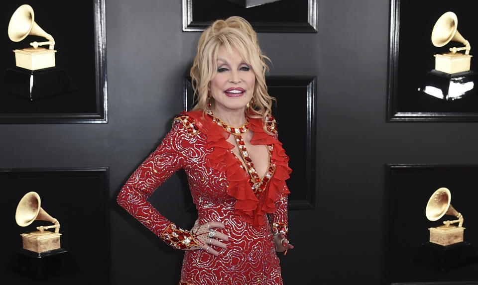 FILE - Dolly Parton arrives at the 61st annual Grammy Awards on Feb. 10, 2019, in Los Angeles. Parton is among the entertainers who took the initiative to make the best out of a challenging year. The country music icon donated $1 million toward researching the coronavirus at Vanderbilt University Medical Center in Nashville, Tenn. (Photo by Jordan Strauss/Invision/AP, File)