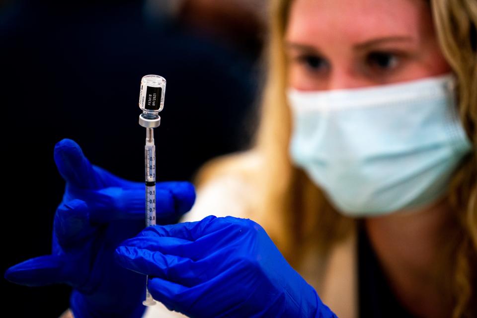 Caroline Elcan, an advanced practice registered nurse, prepares a COVID-19 vaccine dose during a vaccination event at John Overton High School in Nashville, Tenn., Monday, Dec. 6, 2021.