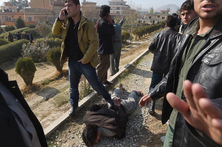 An Afghan intelligence officer arrests a man suspected of placing explosives in the Wazir Akbar Khan area of Kabul, on November 25, 2014