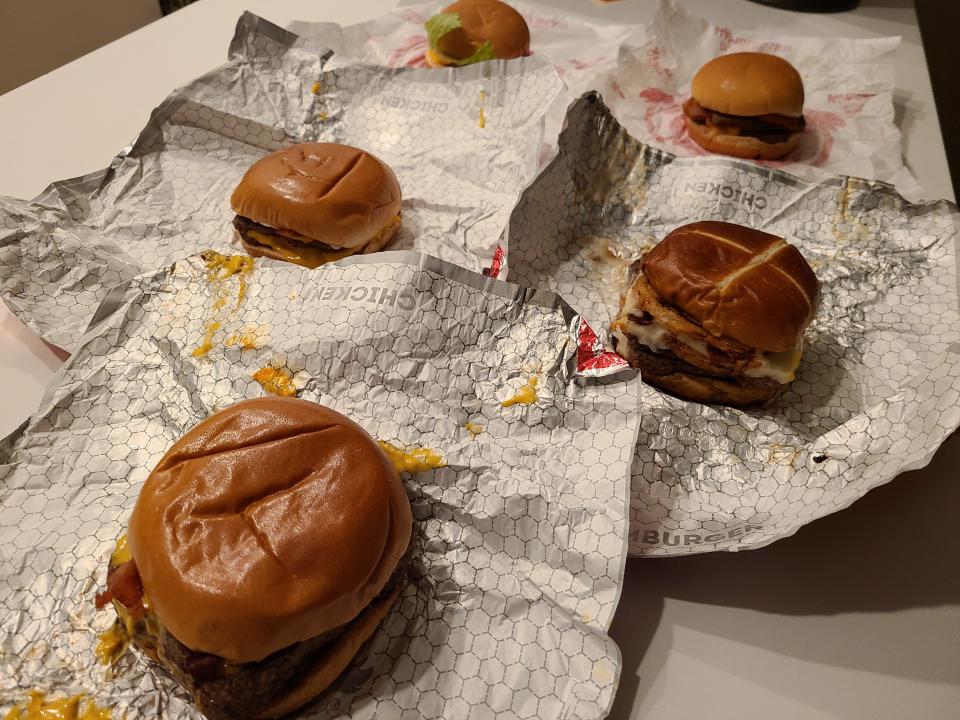 wendy's burgers on wrappers on a white counter