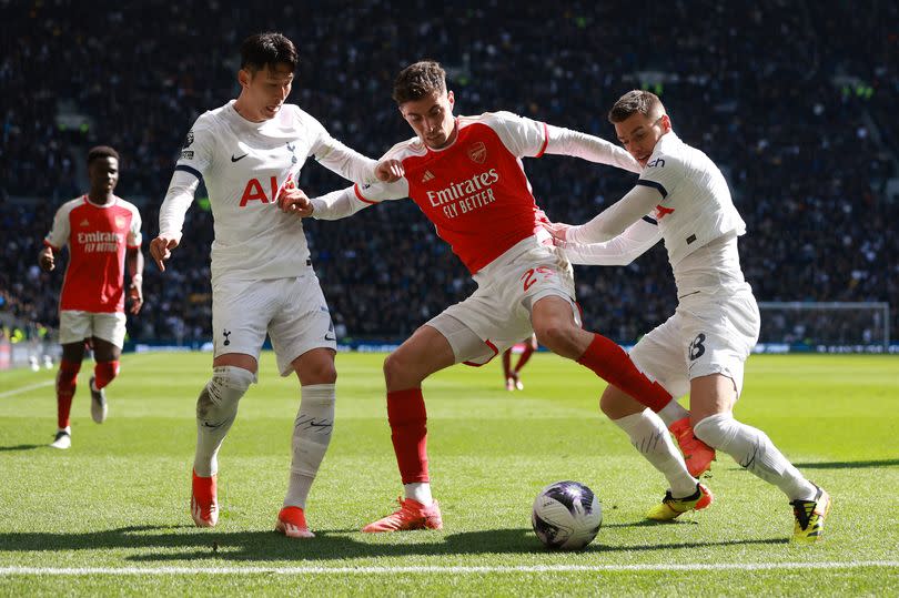 Arsenal and Tottenham Hotspur battle for possession in the North London Derby