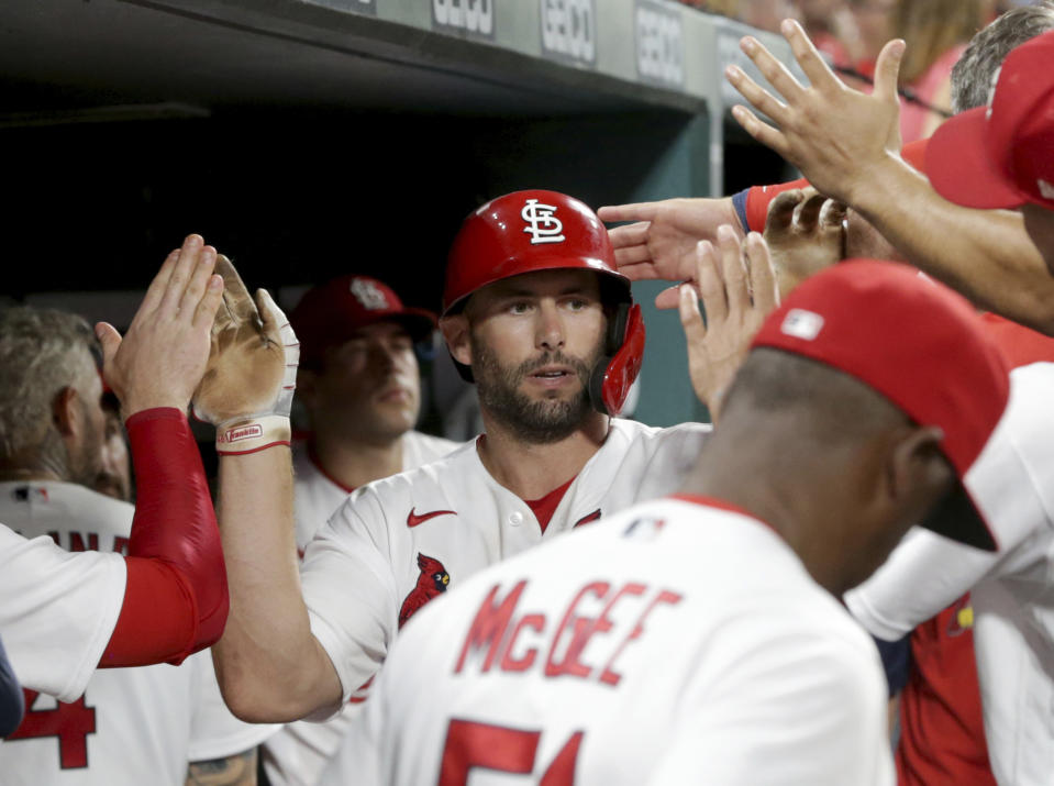 St. Louis Cardinals' Paul Goldschmidt (46) is congratulated by teammates in the dugout after hitting a solo home run in the seventh inning of a baseball game against the San Francisco Giants, Friday, July 16, 2021, in St. Louis. (AP Photo/Tom Gannam)