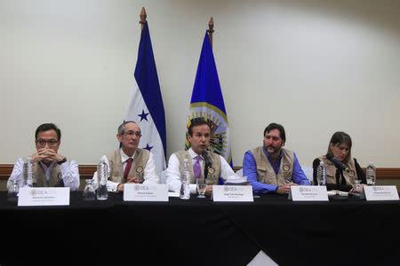 Jorge Tuto Quiroga (C), chief of the Organization of American States (OAS) electoral observer mission, speaks next to colleges during a news conference in Tegucigalpa, Honduras December 17, 2017. REUTERS/ Jorge Cabrera