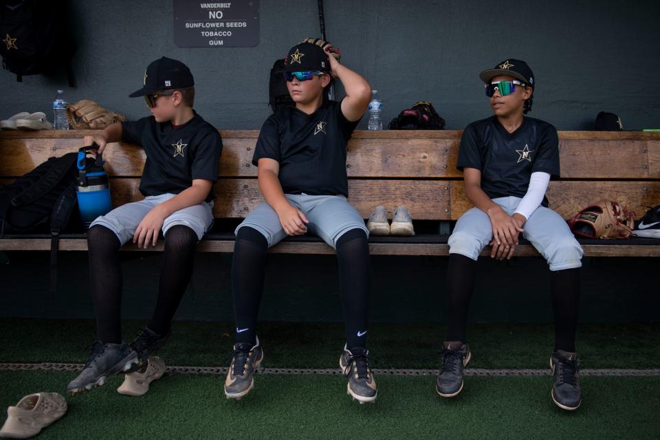 Turner Black, 12, Jackson Tabor, 12, Ty McKenzie II, 12 sit in the dugout during their team’s practice at Hawkins Field at Vanderbilt in Nashville , Tenn., Monday, July 17, 2023.