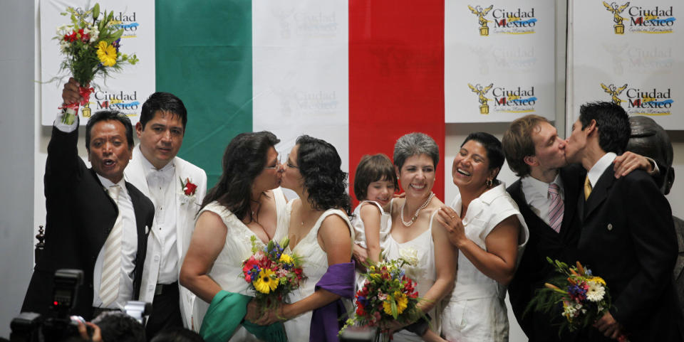 FILE - In this March 11, 2010 file photo, same sex couples celebrate after getting married at City Hall in Mexico City. The couples wed under Latin America's first law that explicitly approves gay marriage. Mexican President Enrique Pena Nieto on Tuesday, May 17, 2016, proposed legalizing gay marriage, a move that would enshrine on a national level a Supreme Court ruling last year that it was unconstitutional for states to bar same-sex couples from wedding.(AP Photo/Eduardo Verdugo, File)