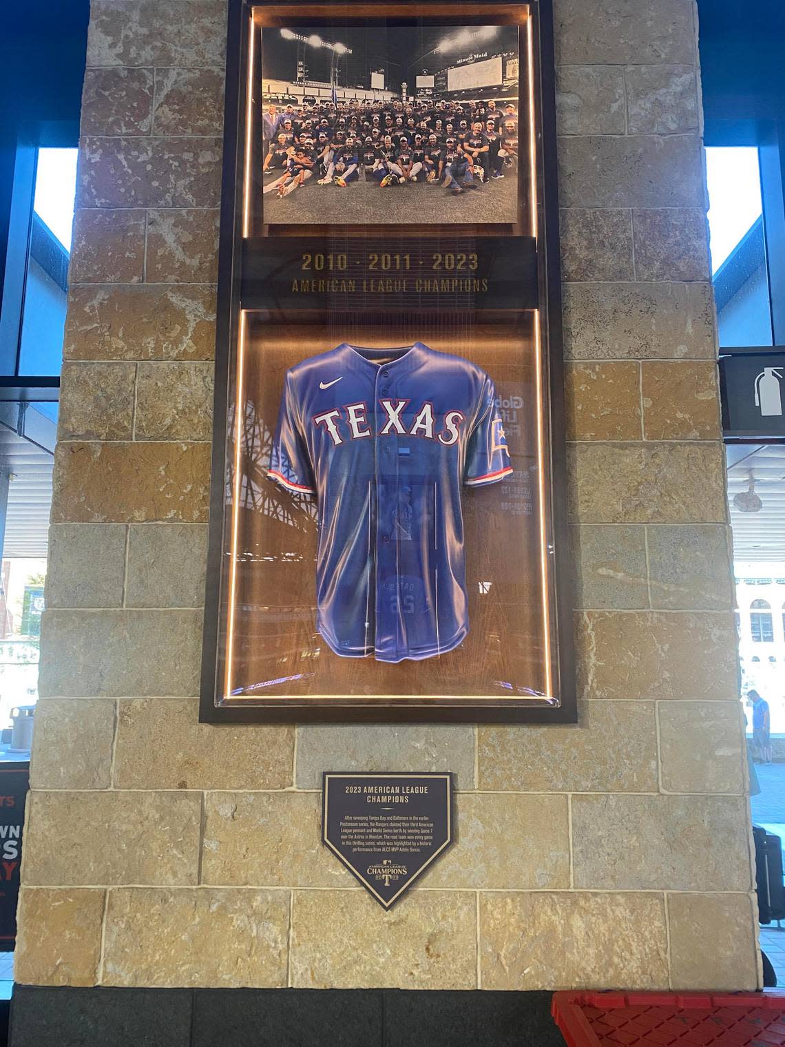 A framed Rangers jersey, photo and plaque located near section 140 at Globe Life Field. Lawrence Dow