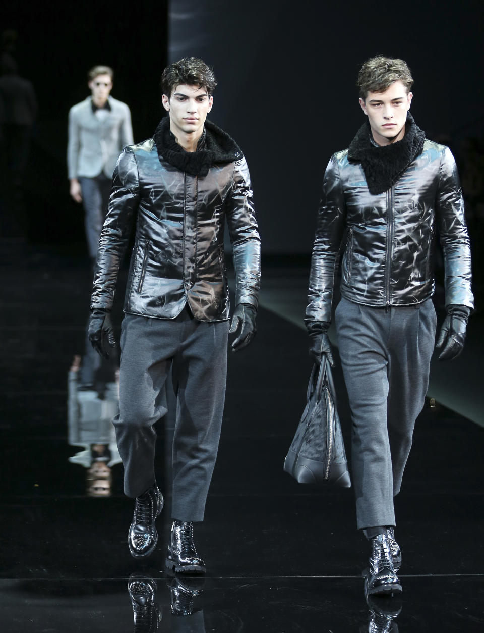 Models wear creations for Emporio Armani men's Fall-Winter 2014 collection, part of the Milan Fashion Week, unveiled in Milan, Italy, Monday, Jan. 13, 2014. (AP Photo/Antonio Calanni)