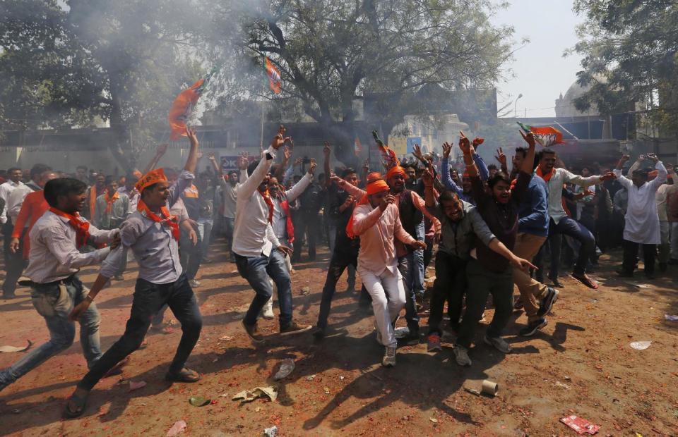 Bharatiya Janata Party supporters celebrate winning seats in the Uttar Pradesh state legislature elections in, Lucknow, India, Saturday, March 11, 2017. India's governing Hindu nationalist party was heading for major victories Saturday in key state legislature elections that are seen as a referendum on the performance of Prime Minister Narendra Modi's nearly 3-year-old government. (AP Photo/Rajesh Kumar Singh)