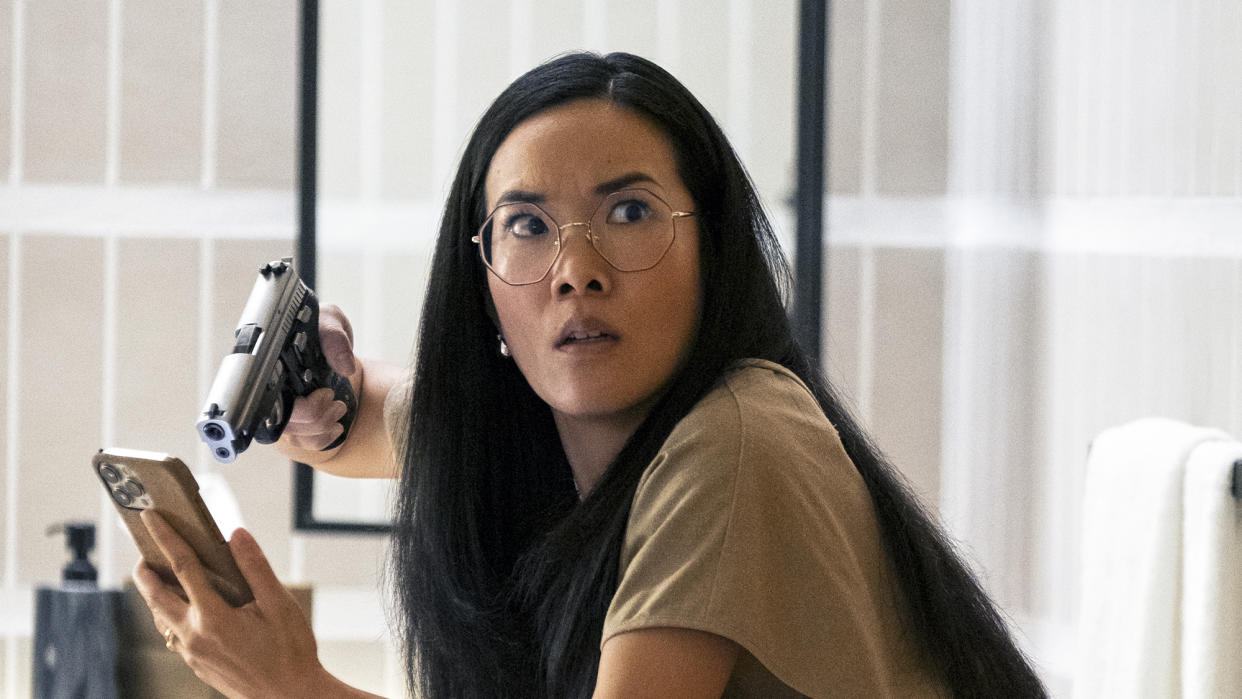  Ali Wong as Amy, pointing a gun at an iPhone in episode 102 of Beef. 