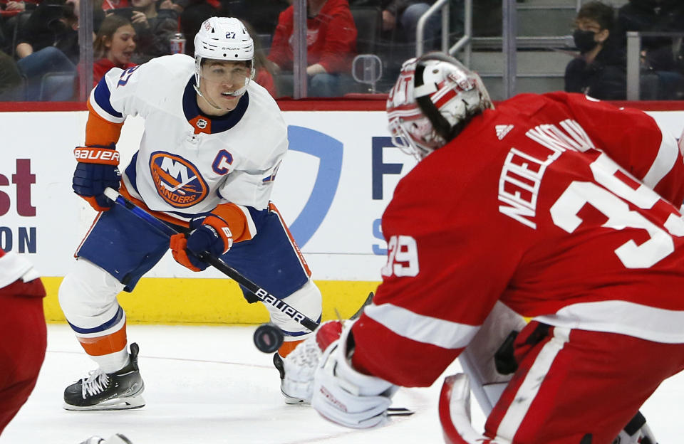 New York Islanders left wing Anders Lee (27) watches his shot against Detroit Red Wings goaltender Alex Nedeljkovic (39) during the second period of an NHL hockey game Saturday, Dec. 4, 2021, in Detroit. (AP Photo/Duane Burleson)