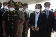 Cambodian Prime Minister Hun Sen, second from right, walks at Phnom Penh International Airport as he returned from Myanmar, in Phnom Penh, Cambodia, Saturday, Jan. 8, 2022. Prime Minister Hun Sen's visit to Myanmar seeking to revive peace efforts after last year's military takeover has provoked an angry backlash among critics, who say he is legitimizing the army's seizure of power. (AP Photo/Heng Sinith)