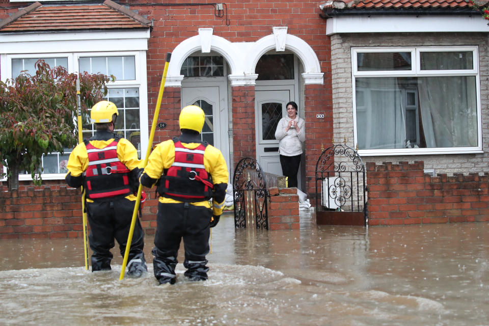 Fire and Rescue service members walk through flood water to rescue residents in Doncaster, Yorkshire, as parts of England endured a month's worth of rain in 24 hours, with scores of people rescued or forced to evacuate their homes, others stranded overnight in a shopping centre, and travel plans thrown into chaos.