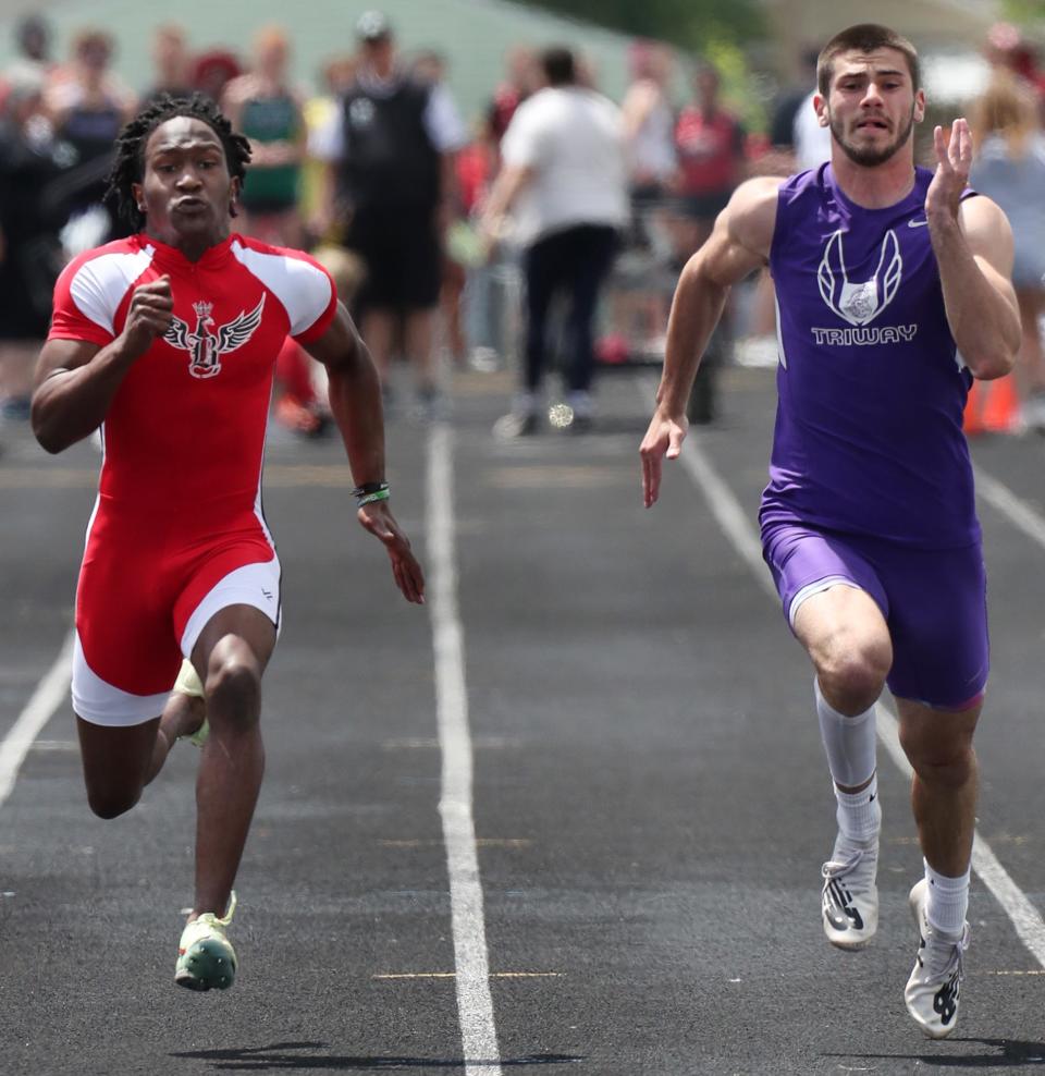 Triway's Cameron Soss, right, races to a third place finsh as Buchtel's Monte Blair comes in fifth in the boys 100 meter dash at the Div. II regional track and field tournament at Austintown Fitch High School on Saturday.