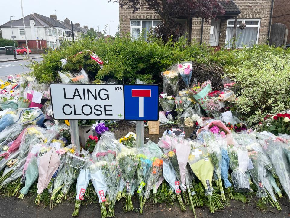 Floral tributes at the end of Laing Close near the scene in Hainault, north east London (PA Wire)