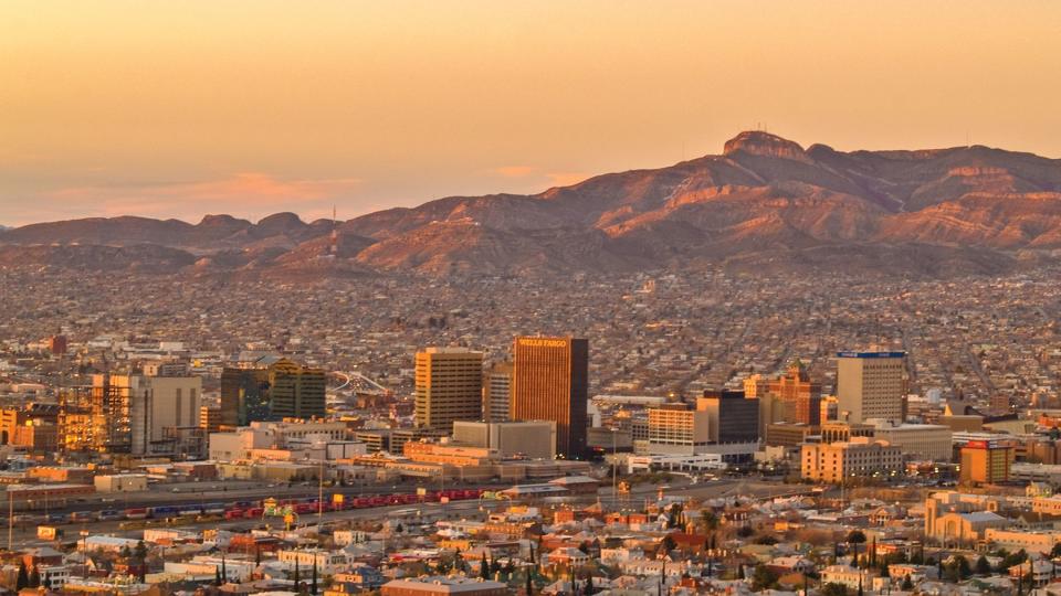 El Paso and Juarez are illuminated by the natural soft light under a beautiful orange sky