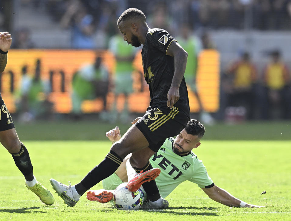 Austin FC midfielder Felipe Martins, right, takes the ball from Los Angeles FC midfielder Kellyn Acosta, top, during the first half of an MLS playoff Western Conference final soccer match Sunday, Oct. 30, 2022, in Los Angeles. LAFC won 3-0.(AP Photo/John McCoy)