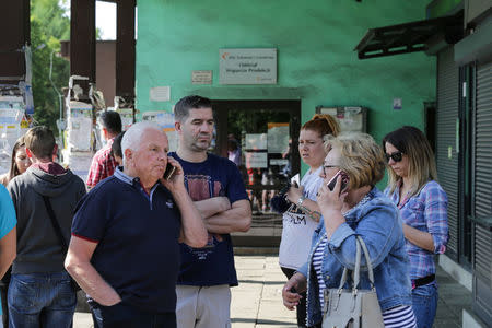 People wait outside the JSW mine where coal miners are missing underground after a strong quake hit a mine in Jastrzebie Zdroj, Poland May 5, 2018. Agencja Gazeta/Dominik Gajda via REUTERS