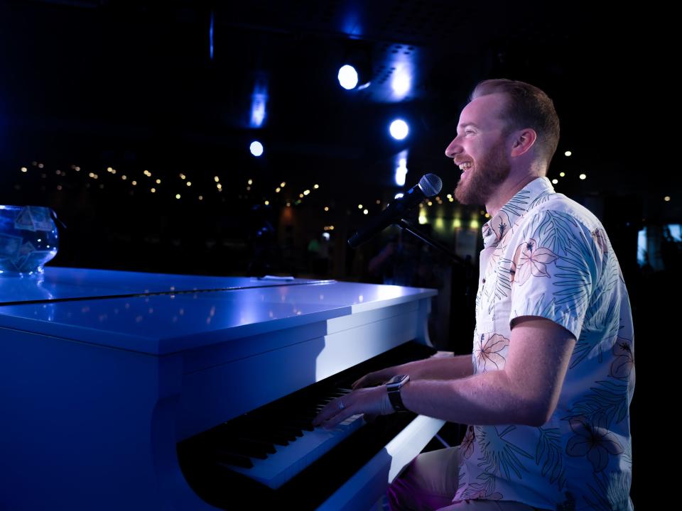 A pianist and piano on the Margaritaville at Sea Paradise