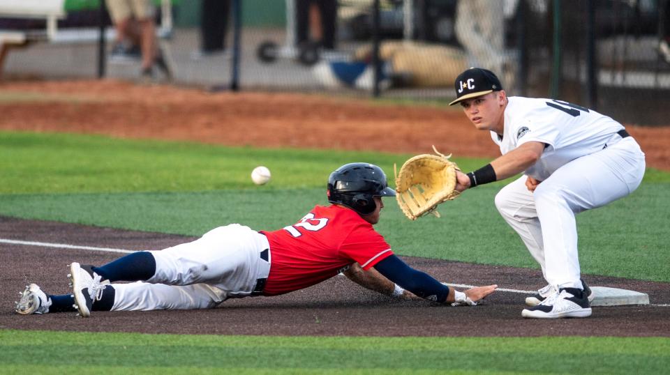 Bristol State Liners' Chandler Blackwelder dives back to first base as Johnson City Doughboys' Cherokee Nichols takes the throw during an Appalachian League game in June.