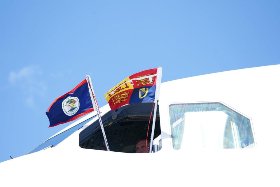 The Royal Standard and the flag of Belize are flown from the window of the cockpit ahead of the departure of the then Duke and Duchess of Cambridge from Belize in March (Jane Barlow/PA) (PA Wire)